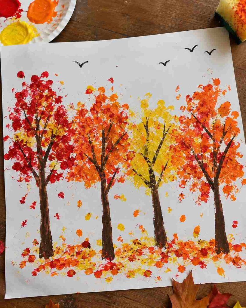 21 Easy & Creative Fall Crafts for Kids to Make at Home 13 11. Sponge-Painted Fall Trees for Kids Create a colorful autumn forest with a simple sponge-painting technique. Kids can dab red, orange, and yellow paint around tree branches to make beautiful fall foliage. This easy art project is perfect for preschoolers and kindergarteners. Materials Needed: - White paper - Red, orange, and yellow washable paint - Small sponge or cotton balls - Brown or black marker - Paper plate for paint How to Make It: 1. Draw a few tree trunks and branches on white paper using a brown or black marker. 2. Pour small drops of fall-colored paint onto a paper plate. 3. Dip a sponge or cotton ball into the paint and gently dab around the branches to create colorful leaves. 4. Add a few paint dots beneath the trees to represent fallen leaves. 5. Let the painting dry, then draw tiny birds in the sky if desired. Quick Tip: Let kids overlap the colors and leave a few white spaces for a natural, handmade look.