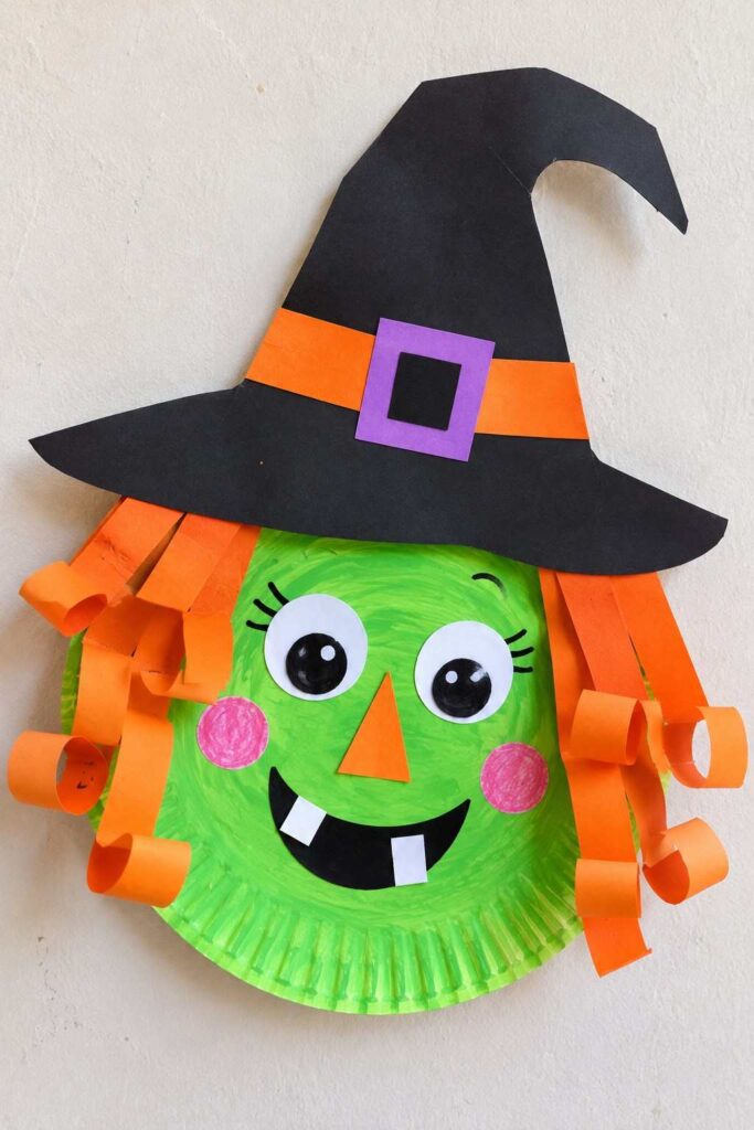 21 Easy & Creative Fall Crafts for Kids to Make at Home 9 ### 7. Funny Paper Plate Witch Craft for Kids Make Halloween extra fun with this silly paper plate witch! Her bright green face, curly orange paper hair, crooked black hat, and funny buck teeth give this easy craft lots of personality. It’s a great Halloween activity for preschoolers and kindergarteners, using simple materials that are easy to find at home. Materials Needed: - 1 paper plate - Green paint or green construction paper - Black, orange, purple, and white construction paper - Glue stick - Child-safe scissors - Black marker How to Make It: 1. Paint the paper plate green and let it dry, or cover it with green paper. 2. Cut a large witch hat from black paper. Add an orange band and a small purple buckle, then glue it to the top of the plate. 3. Cut orange paper into thin strips. Curl some strips around a pencil and glue them along both sides of the face for messy witch hair. 4. Add two large paper eyes, an orange triangle nose, and pink paper cheeks. 5. Cut a wide black smile and two small white teeth, then glue them onto the face. Quick Tip: Make the hair extra curly and the teeth a little uneven to give your witch a funny, playful expression!